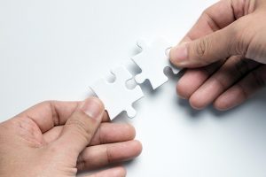 Partnership concept with hands putting puzzle pieces together