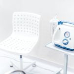 Chair and medical device in hospital room. Blood pressure and oxygen ventilation device