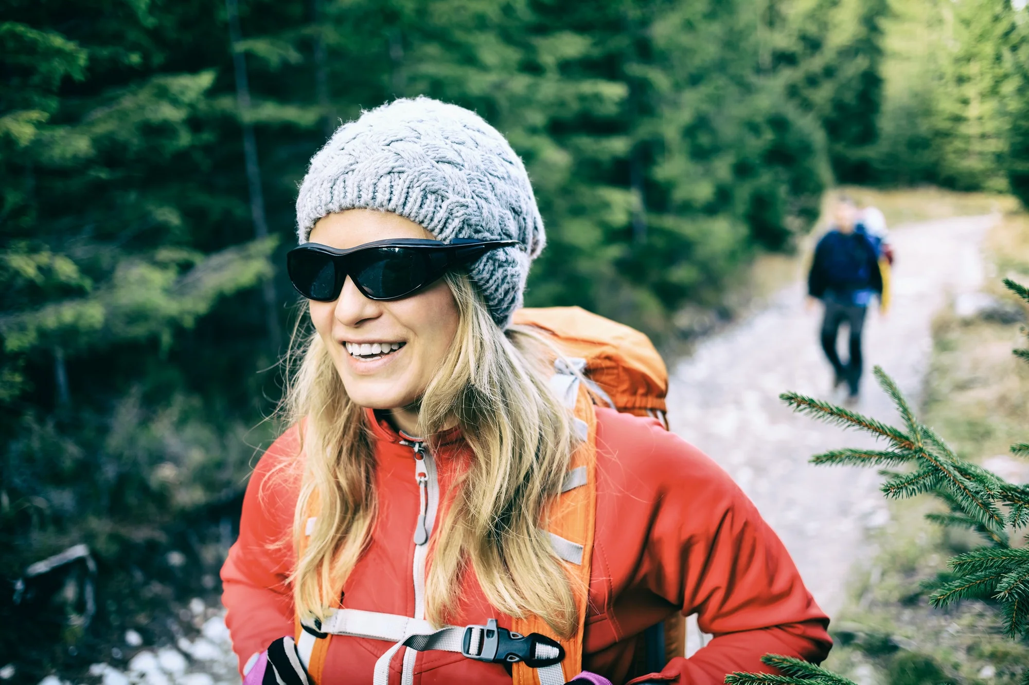 Couple hikers walking on trail in forest