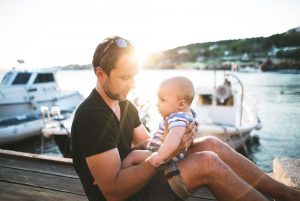 Man with baby son enjoying their time at seaside.