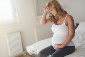 Pregnant woman suffering with headache