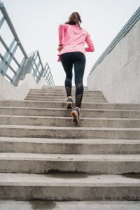 Sport woman running on stairs.